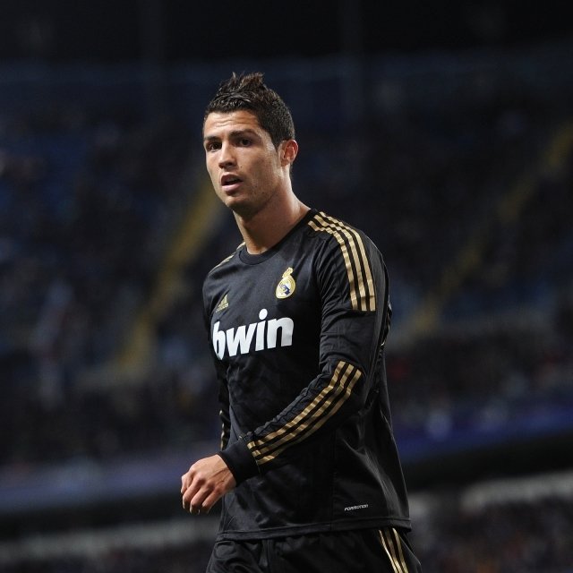 Cristiano Ronaldo in a black Real Madrid jersey during a match, captured as a dynamic sports profile photo.
