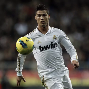 Forum avatar/pfp: male soccer player in a white Real Madrid kit controlling a yellow ball during play.