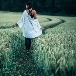 Girl walking in a wheat field by Clem Onojeghuo