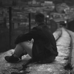  Guy Sitting On Rails by Simone Acquaroli