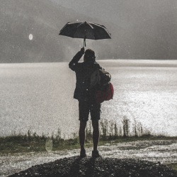 Man under an umbrella by Lukas Budimaier
