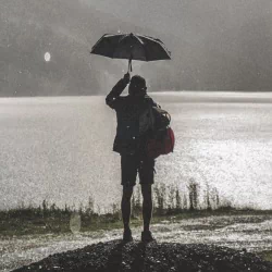  Man under an umbrella by Lukas Budimaier