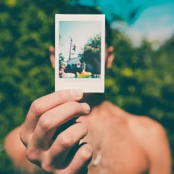  Man holds a photo in his hand by Jakob Owens