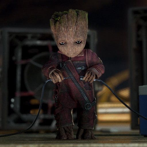 Forum avatar of baby Groot from the movie Guardians of the Galaxy Vol. 2, standing on a dimly lit sci‑fi set while holding cables.