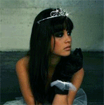 A beautiful woman with long dark hair and a tiara, posing thoughtfully in a forum avatar style image.