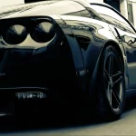 Close-up avatar image of a sleek Corvette sports car, highlighting the distinctive headlights and front grille design.