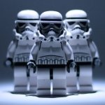 A trio of LEGO stormtroopers stands against a dark background, showcasing their iconic white armor, embodying the essence of the Star Wars universe.