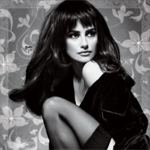 Black-and-white forum avatar/pfp of a seated woman with long dark hair and bangs, striking glamorous retro pose against a patterned backdrop.
