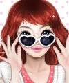 Illustrated red-haired woman in heart-shaped sunglasses, hands framing her face with a playful smile against a pink, heart-dotted background — forum avatar/profile photo.