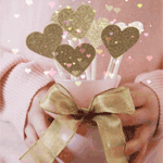 Artistic forum avatar/pfp: hands in a soft pink sweater holding three glittering heart lollipops tied with a gold bow.