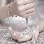 Close-up forum avatar of a beautiful woman: soft-focus hands with glitter cascading between cupped palms.