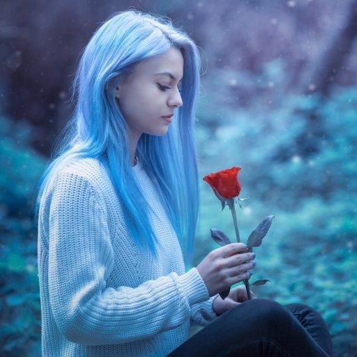 Forum avatar of a woman model with blue hair, holding a red rose in a contemplative, moody outdoor setting.