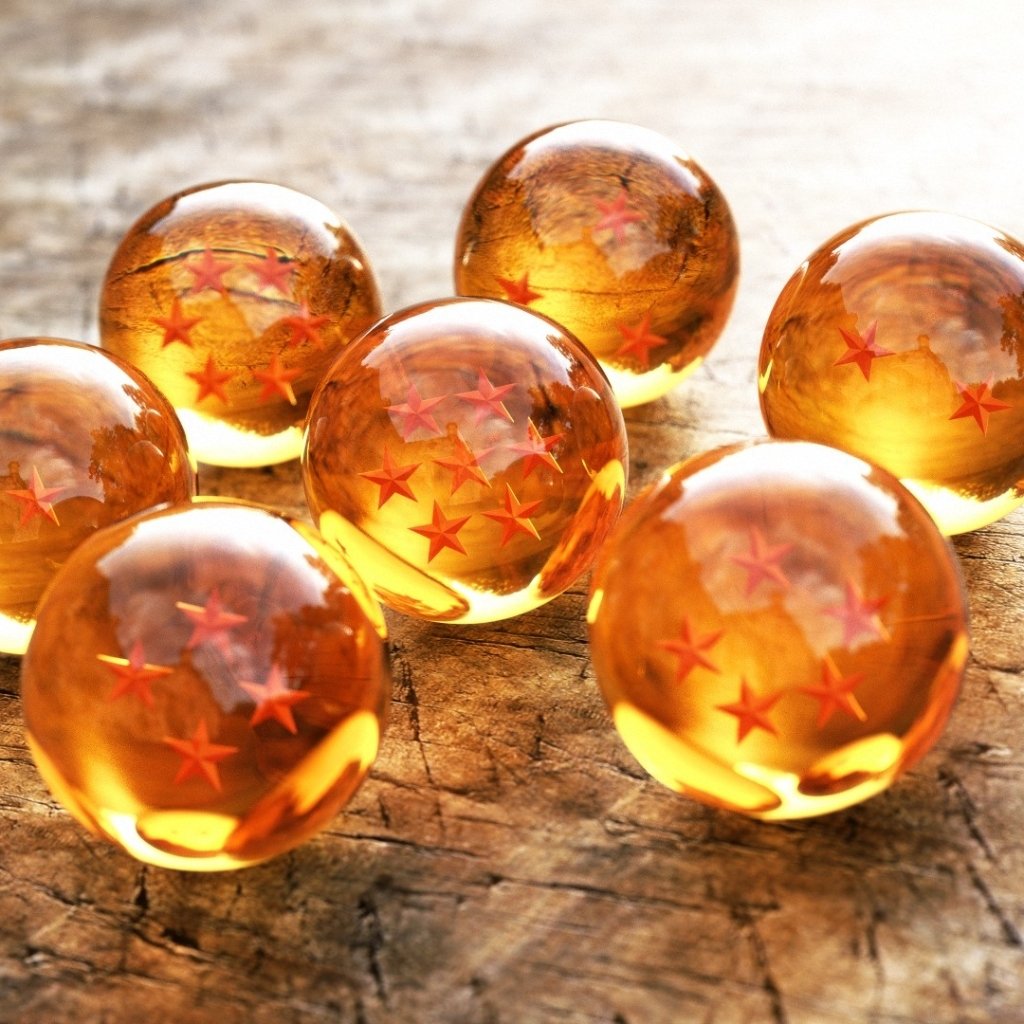 Seven orange Dragon Balls with red stars arranged on a wooden surface, representing iconic items from the Dragon Ball anime series.