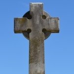Religious forum avatar showing a weathered stone cross against a clear blue sky.