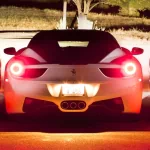 Avatar image featuring the rear view of a Ferrari F430 against a sunset backdrop, highlighting the iconic round taillights and the prancing horse emblem.