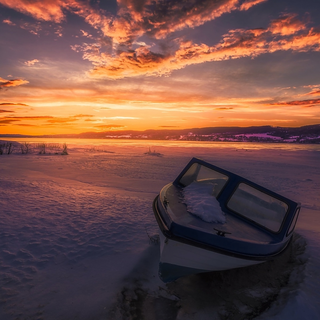 Boat on Winter Lake at Sunset