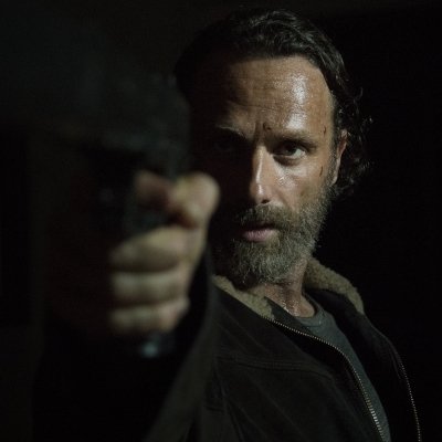 Forum avatar of a bearded, intense character from the TV show The Walking Dead pointing a gun in dim light.