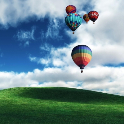 Hot Air Balloons over Green Field