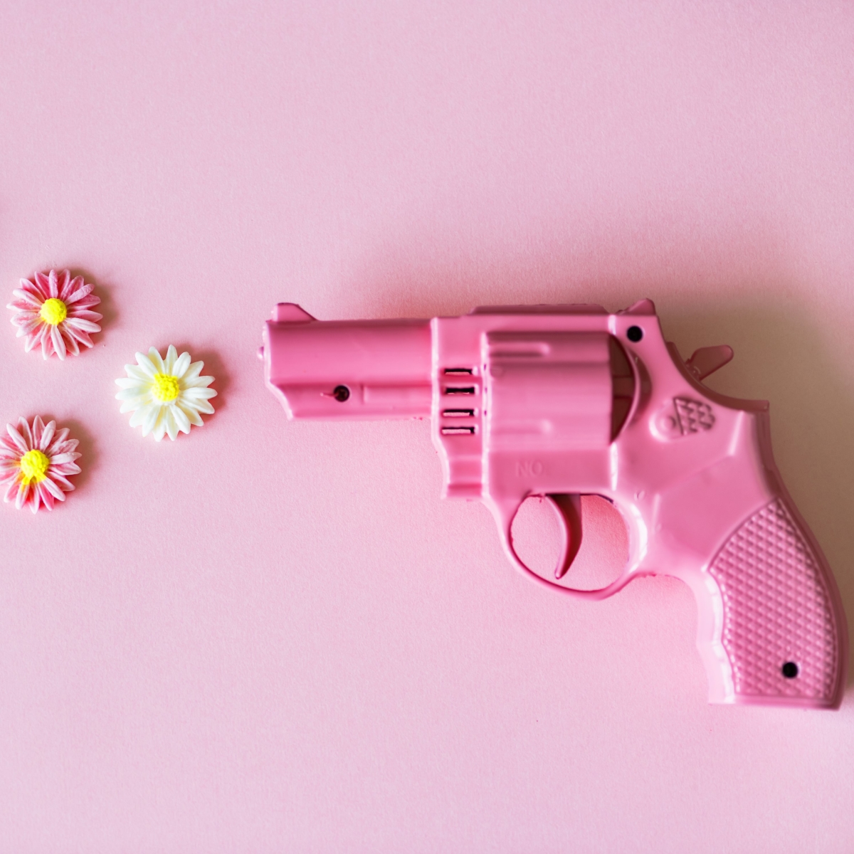 Small Pink Revolver Shooting Flowers by rawpixel