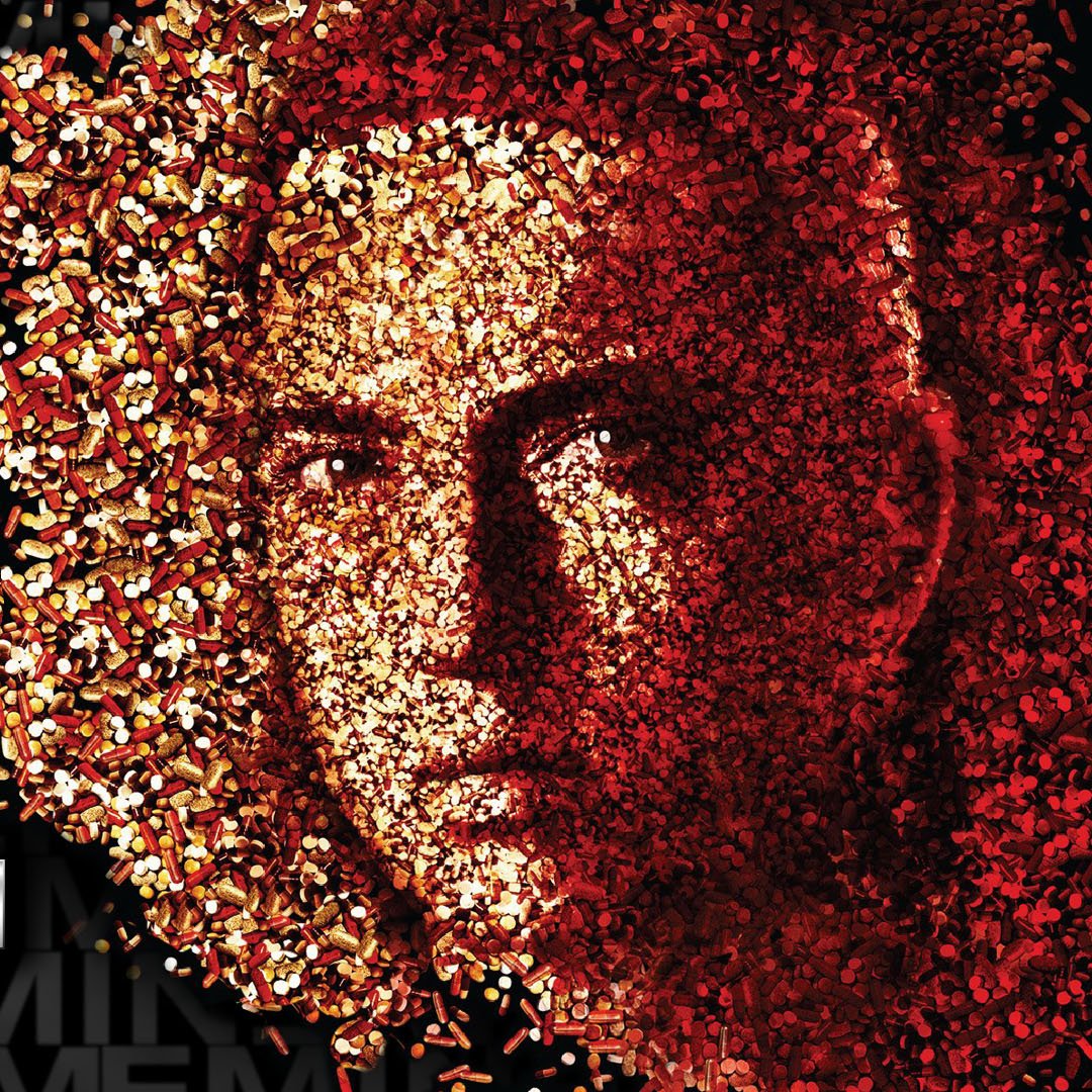Music-themed forum avatar: a rapper's face emerging from dense red and gold confetti particles, stylized high-contrast profile.