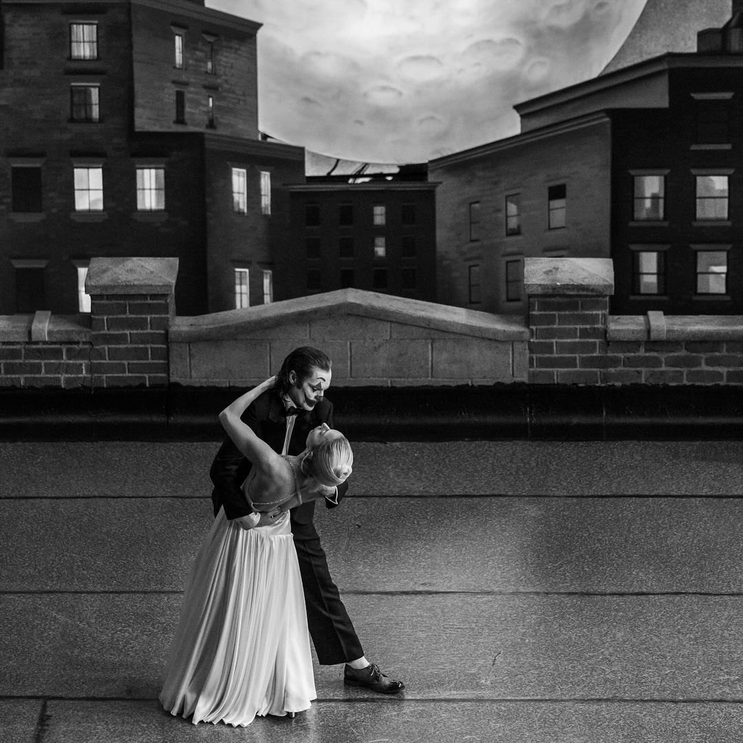 A black and white image depicting two characters dancing on a city rooftop at dusk, tagged as related to the movie Joker: Folie à Deux, used as an avatar/profile picture.