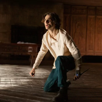 Avatar of a young man in a cream shirt and dark pants from the movie Dune (2021), poised with intensity in a dramatic scene.