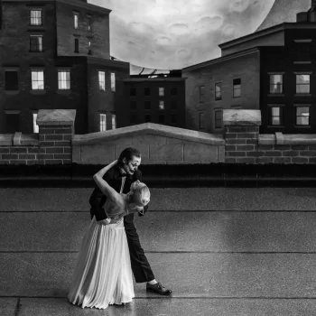 A black and white image depicting two characters dancing on a city rooftop at dusk, tagged as related to the movie Joker: Folie à Deux, used as an avatar/profile picture.