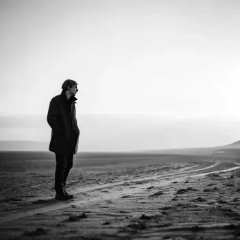 A solitary figure stands on a desolate path, embodying a sense of solitude, captured in a black and white profile photo suitable for a forum avatar.