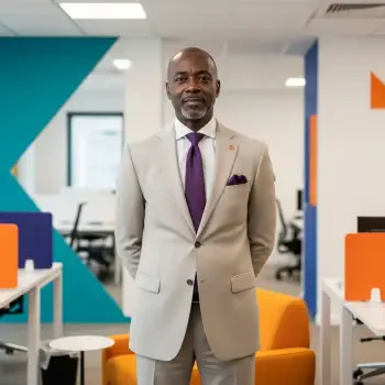 Corporate forum avatar showing a confident man in a beige suit with a purple tie, standing in a modern office setting.