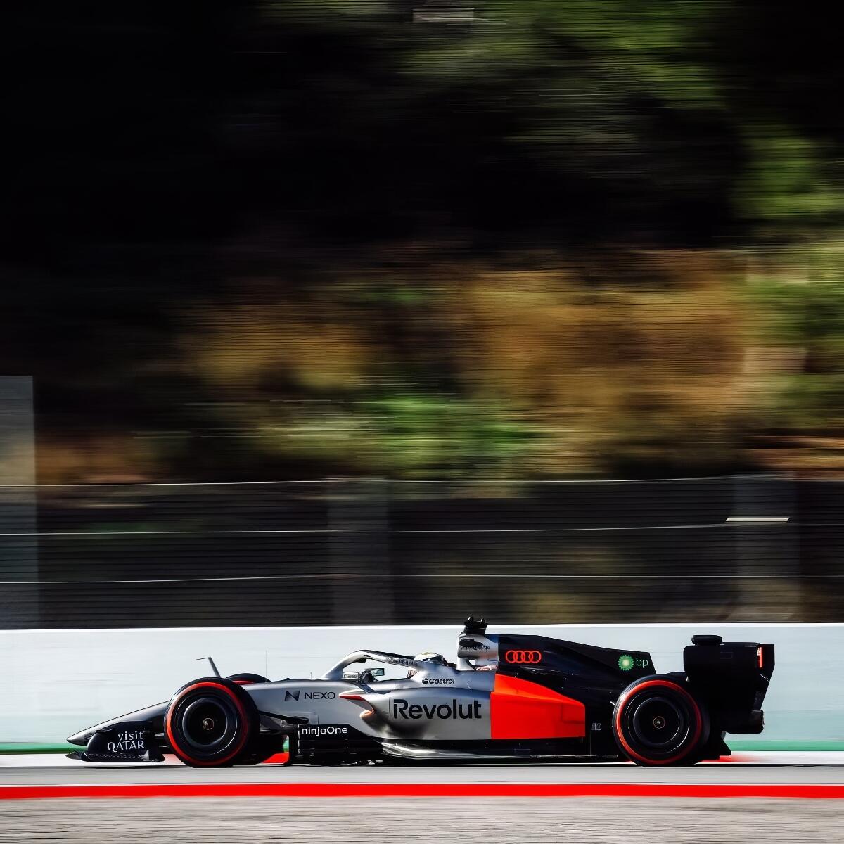 Forum avatar/profile photo of an Audi F1 race car racing on track, silver-and-black livery with red accents and Revolut sponsorship.