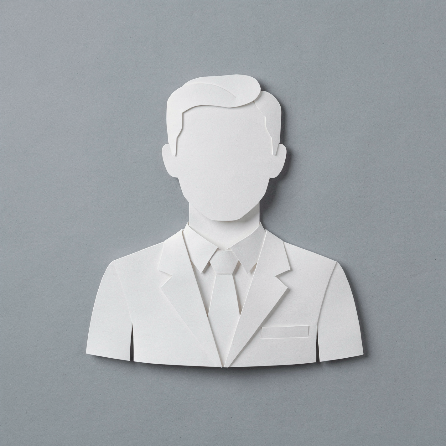 Paper-cut white silhouette in suit and tie on gray background — forum avatar/profile photo representing a lawyer.