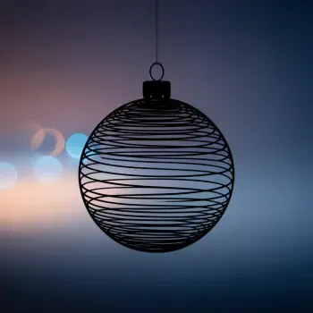 Wire-frame bauble ornament silhouette suspended against a soft, out-of-focus bokeh background — a minimalist forum avatar/pfp.