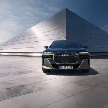 Forum avatar/profile photo of a black BMW i7 luxury vehicle — front view parked before a modern geometric building.