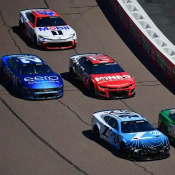 Forum avatar/pfp: aerial view of five NASCAR sports race cars (vehicles) racing in a tight pack on the track.