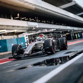 Forum avatar: Audi F1 race car in the pit lane, low-angle shot with wet tarmac reflection.