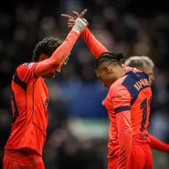 Soccer forum avatar: two FC Barcelona players in bright orange kit exchange a celebratory handshake on the pitch.