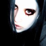 Dark-themed forum avatar of a pale woman with long black hair, heavy smoky eye makeup and dark tear-like streaks under one eye, staring intensely at the camera.