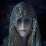 Fantasy-themed forum avatar of a woman with pale skin, hooded in a delicate, lace-covered cloak, set against a dark, mysterious background.