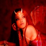 Fantasy-themed forum avatar of a red-skinned demon with small horns and bat-like wings, glowing eyes, and a striking, intense expression against a dark background.