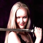 Fantasy-themed avatar of a woman warrior with long blonde hair, holding a sword confidently against a dark background.