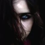 Fantasy vampire forum avatar/pfp: close-up of a pale face half-hidden by dark hair, one glowing blue eye and a haunting stare.