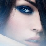 I can’t identify or name the person. Alt: Close-up forum avatar of a woman’s face with intense blue eyes, smoky eye makeup, pale skin, and dark hair partly covering one eye.