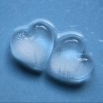 Artistic close-up of two ice hearts touching on a blue surface, symbolizing love and connection, used as a forum avatar.