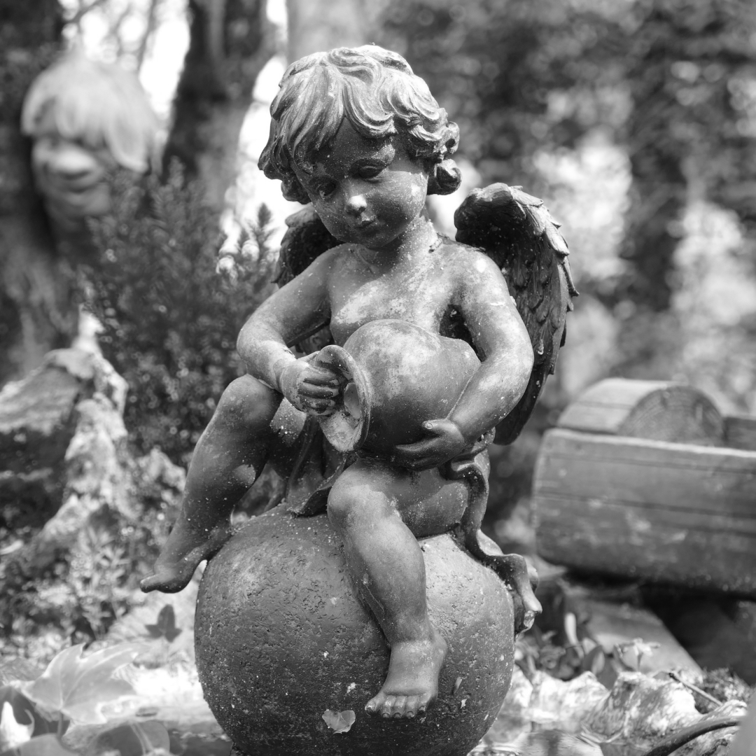 A cherub statue in a garden by jurasud